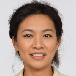 Joyful asian young-adult female with medium  brown hair and brown eyes