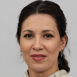 Joyful white adult female with medium  brown hair and brown eyes