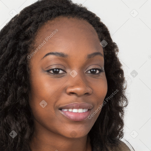 Joyful black young-adult female with long  brown hair and brown eyes