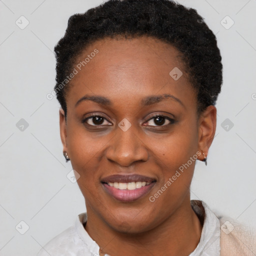 Joyful black young-adult female with short  black hair and brown eyes