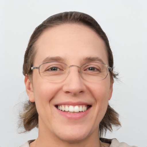 Joyful white adult female with medium  brown hair and grey eyes