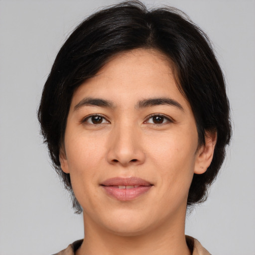 Joyful asian young-adult female with medium  brown hair and brown eyes