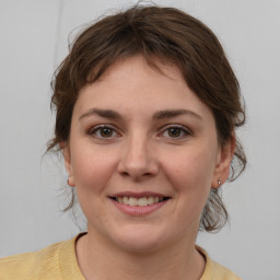 Joyful white young-adult female with medium  brown hair and brown eyes