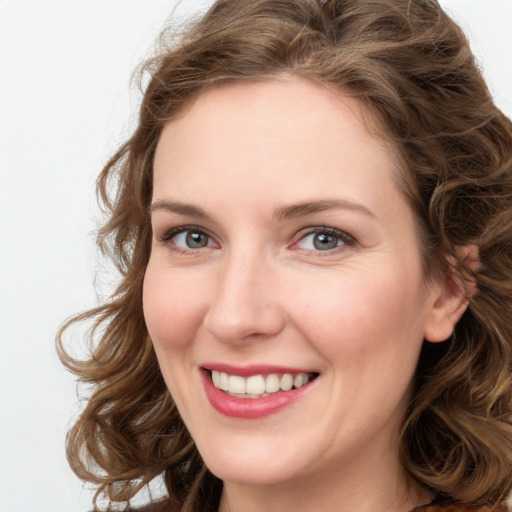 Joyful white young-adult female with long  brown hair and green eyes