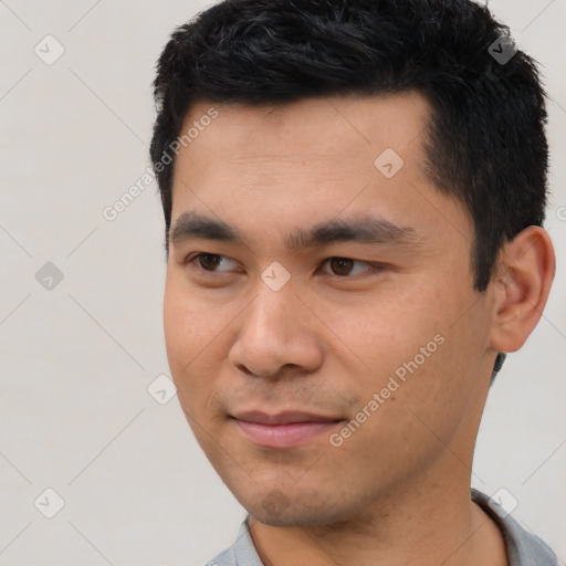 Joyful latino young-adult male with short  black hair and brown eyes