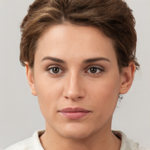 Joyful white young-adult female with short  brown hair and grey eyes