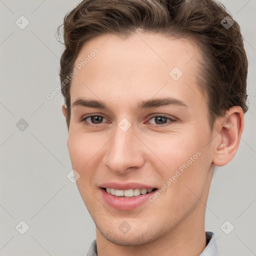 Joyful white young-adult female with short  brown hair and grey eyes