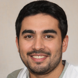 Joyful white young-adult male with short  black hair and brown eyes