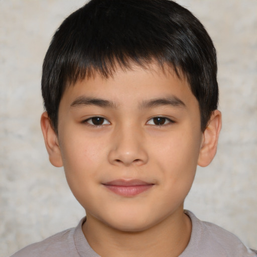 Joyful asian child male with short  brown hair and brown eyes