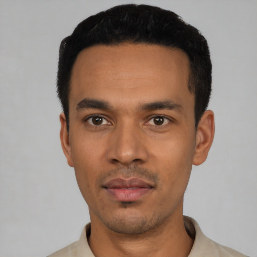 Joyful latino young-adult male with short  black hair and brown eyes