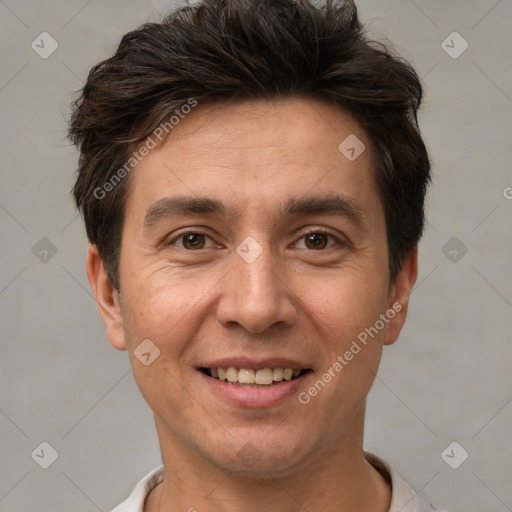 Joyful white adult male with short  brown hair and brown eyes