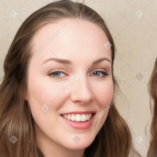 Joyful white young-adult female with long  brown hair and blue eyes