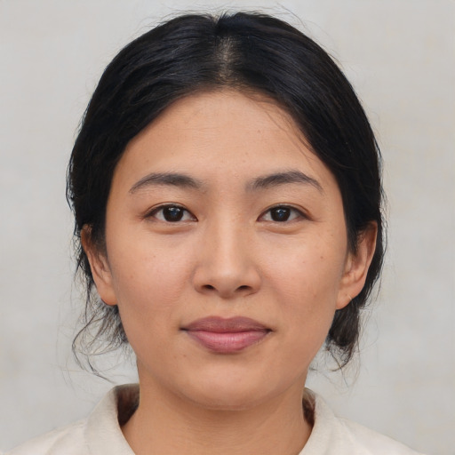 Joyful asian young-adult female with medium  black hair and brown eyes