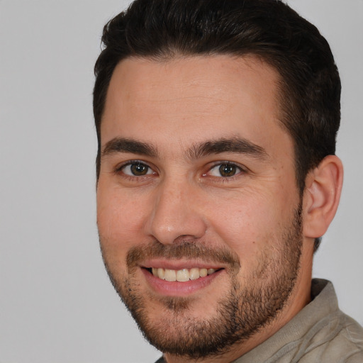 Joyful white young-adult male with short  brown hair and brown eyes