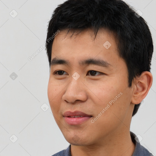 Joyful asian young-adult male with short  black hair and brown eyes