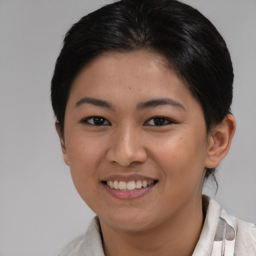 Joyful asian young-adult female with medium  brown hair and brown eyes