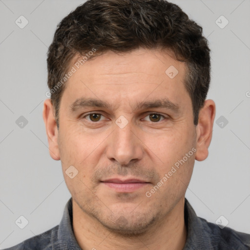 Joyful white adult male with short  brown hair and brown eyes