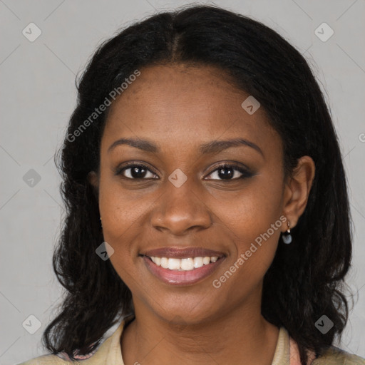 Joyful black young-adult female with long  brown hair and brown eyes