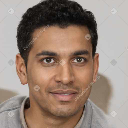 Joyful latino young-adult male with short  brown hair and brown eyes