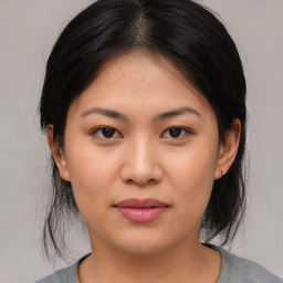 Joyful asian young-adult female with medium  black hair and brown eyes