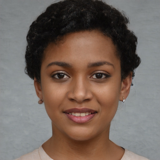 Joyful latino young-adult female with short  black hair and brown eyes