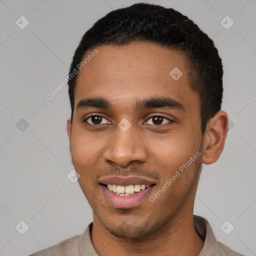 Joyful black young-adult male with short  black hair and brown eyes