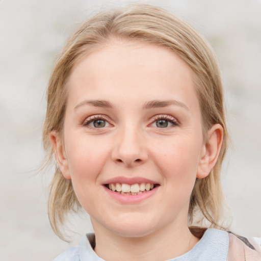 Joyful white young-adult female with medium  brown hair and blue eyes