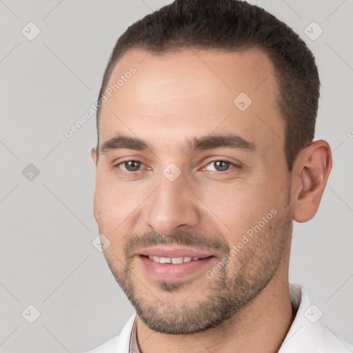 Joyful white young-adult male with short  brown hair and brown eyes