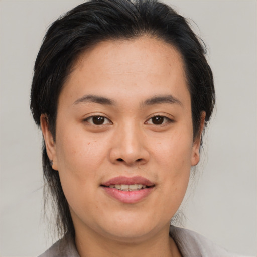 Joyful asian young-adult female with medium  brown hair and brown eyes