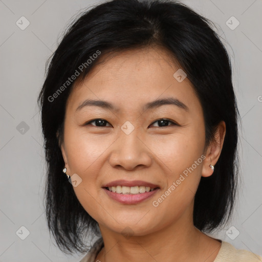 Joyful asian young-adult female with medium  brown hair and brown eyes