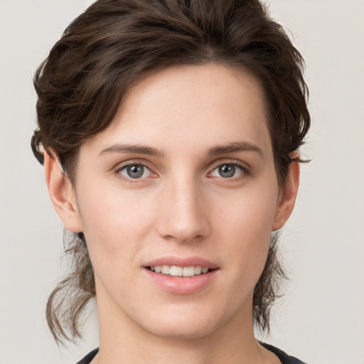 Joyful white young-adult female with medium  brown hair and grey eyes