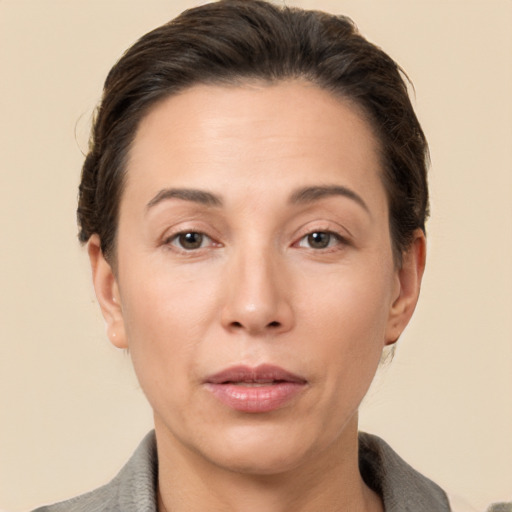 Joyful white adult female with short  brown hair and brown eyes