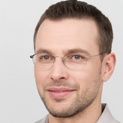 Joyful white adult male with short  brown hair and brown eyes