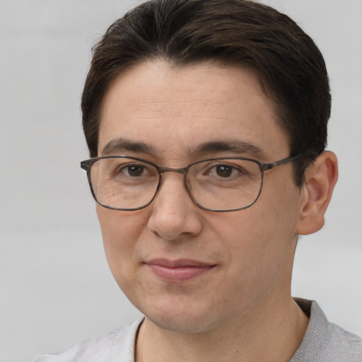 Joyful white adult male with short  brown hair and brown eyes