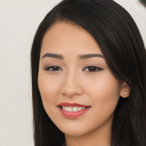 Joyful white young-adult female with long  black hair and brown eyes