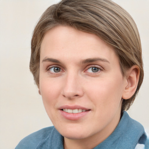 Joyful white young-adult female with short  brown hair and blue eyes