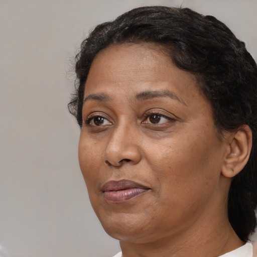 Joyful black adult female with short  brown hair and brown eyes