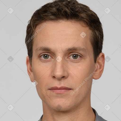 Joyful white adult male with short  brown hair and grey eyes