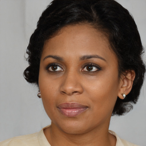 Joyful black young-adult female with medium  brown hair and brown eyes