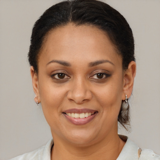 Joyful latino adult female with short  brown hair and brown eyes