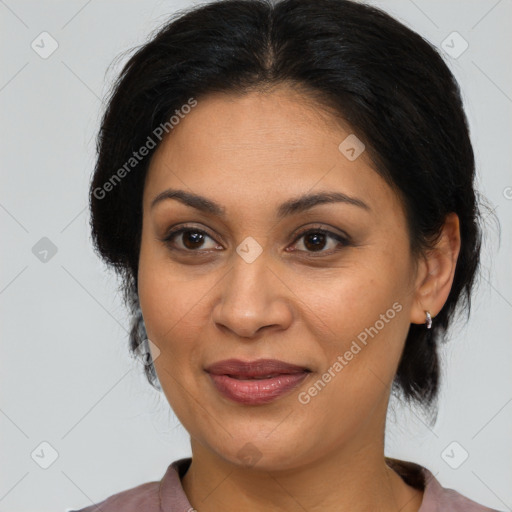 Joyful latino adult female with medium  brown hair and brown eyes