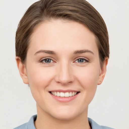 Joyful white young-adult female with short  brown hair and grey eyes