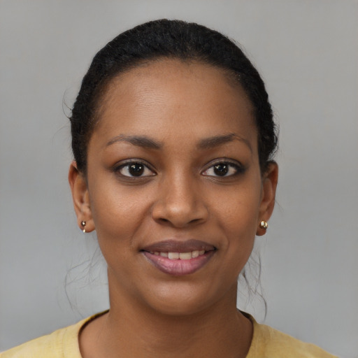 Joyful black young-adult female with short  black hair and brown eyes