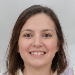 Joyful white young-adult female with medium  brown hair and grey eyes