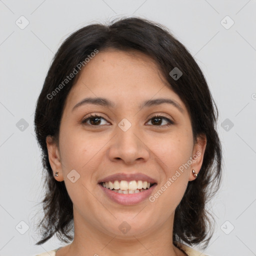 Joyful latino young-adult female with medium  brown hair and brown eyes