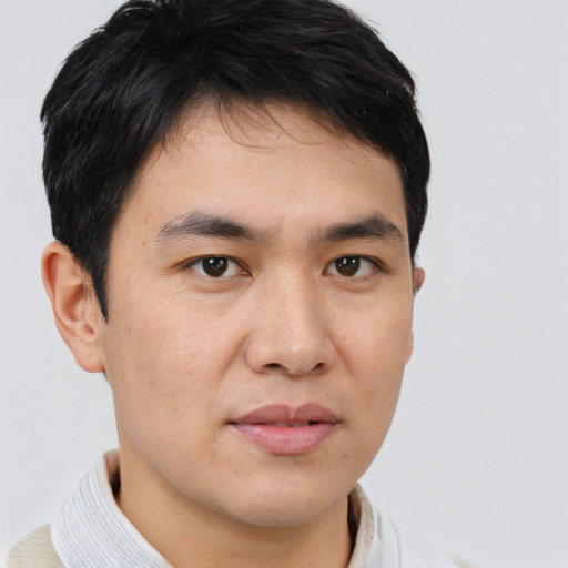 Joyful asian young-adult male with short  brown hair and brown eyes