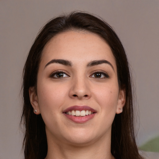 Joyful white young-adult female with long  brown hair and brown eyes