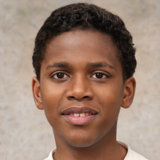 Joyful black child male with short  brown hair and brown eyes