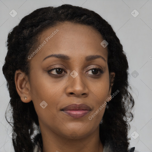 Joyful black young-adult female with long  brown hair and brown eyes