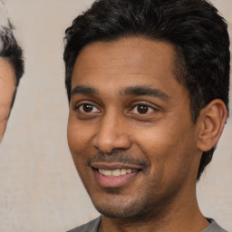 Joyful latino young-adult male with short  black hair and brown eyes